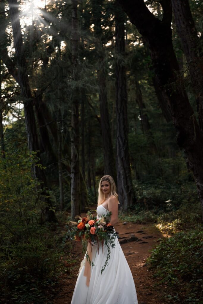 bride holding a bouquet in the forest