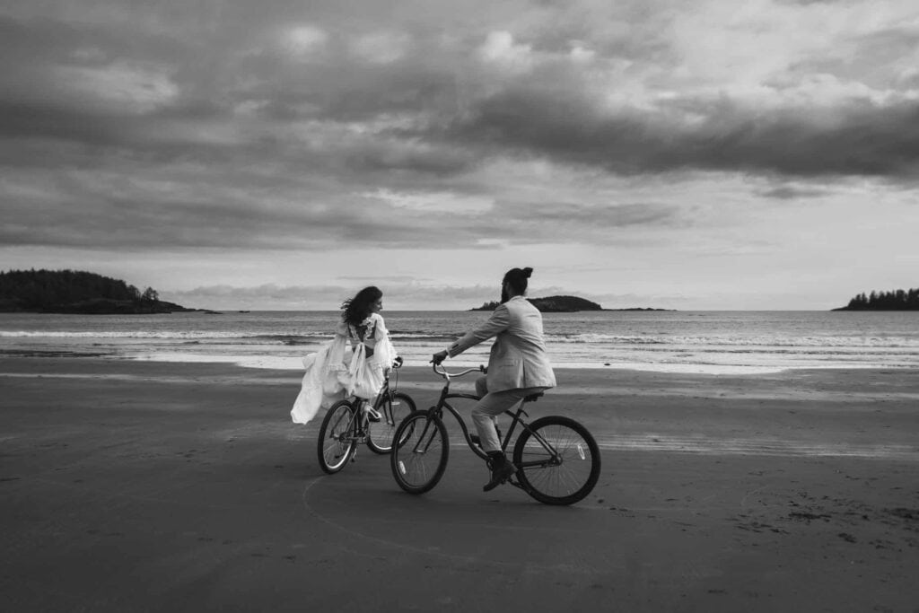 outdoor elopement ideas - riding bikes on the beach