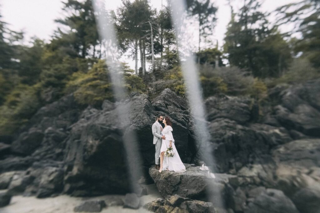 eloping in british columbia-  couple on the beach rocks in tofino