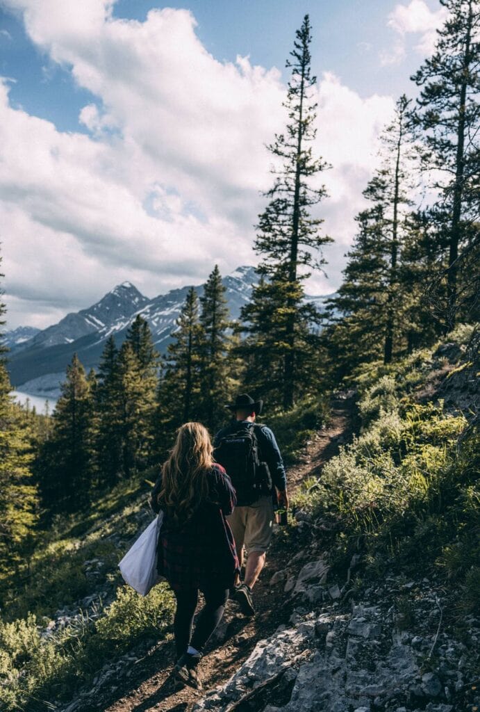 couple hiking down west wind pass