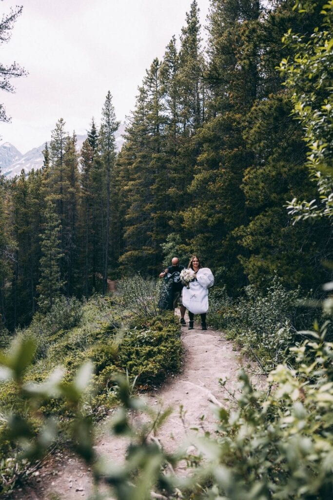 couple hiking up west wind pass