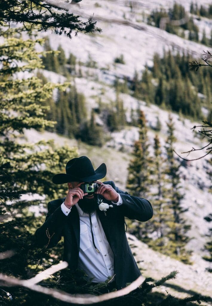 groom taking polaroids of bride