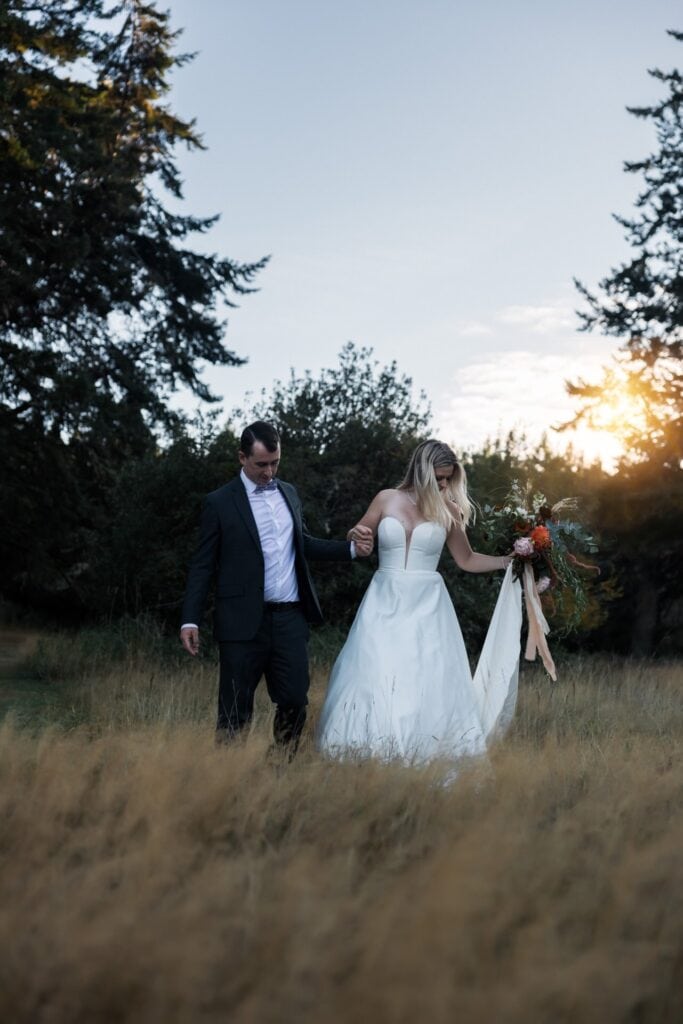 wedding couple walking in field of vancouver island