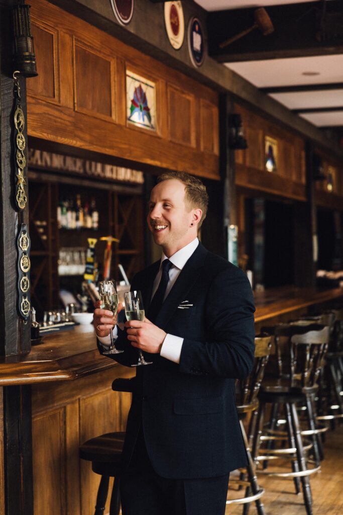 indoor elopement ideas - couple having a drink at the bar