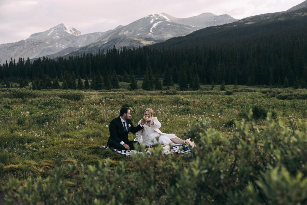 couple having a picnic at bow lake in banff national park