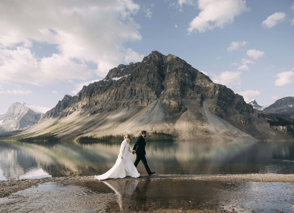 couple walking at bow lake in banff national park