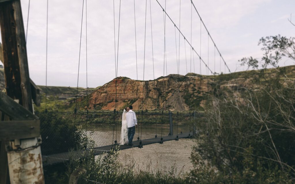 Couple walking across Star Mine Suspension Bridge in Drumheller
