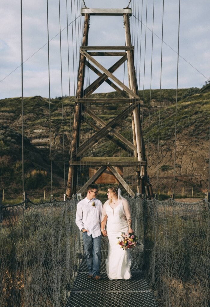 Couple walking across Star Mine Suspension Bridge in Drumheller